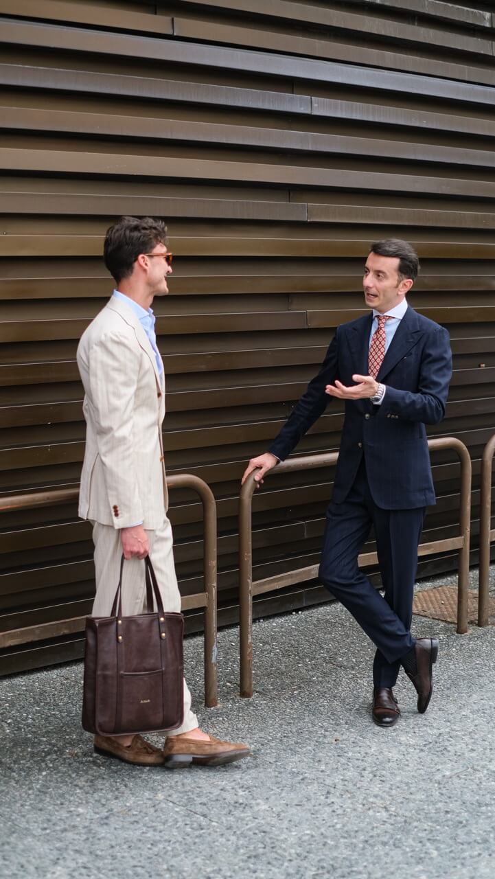 two gentlemen in different styles having a conversation