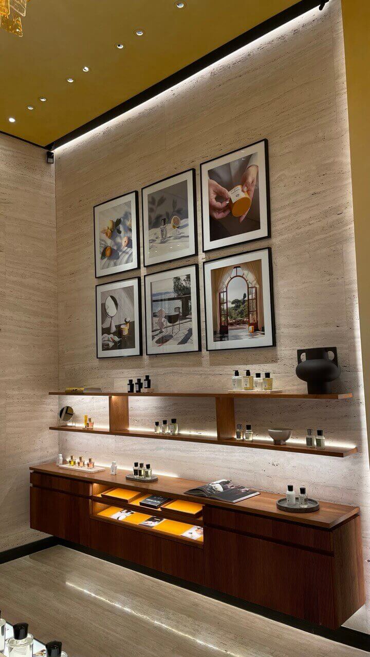A wall of paintings and perfume.