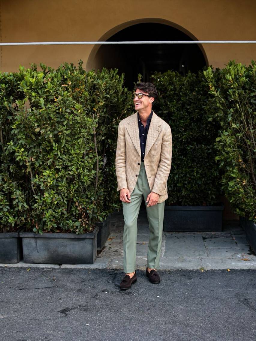 Me at Pitti Uomo summer fashion event in Italy wearing a beige bespoke jacket, dark blue shirt, and woolen olive green trousers