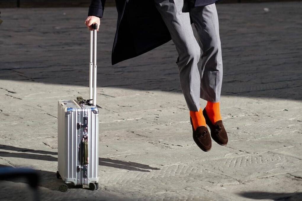 Bright orange socks grey suit austere look for autumn for men