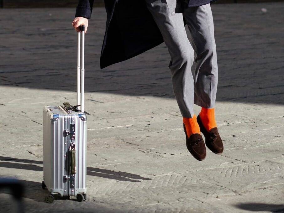 Bright orange socks grey suit austere look for autumn for men